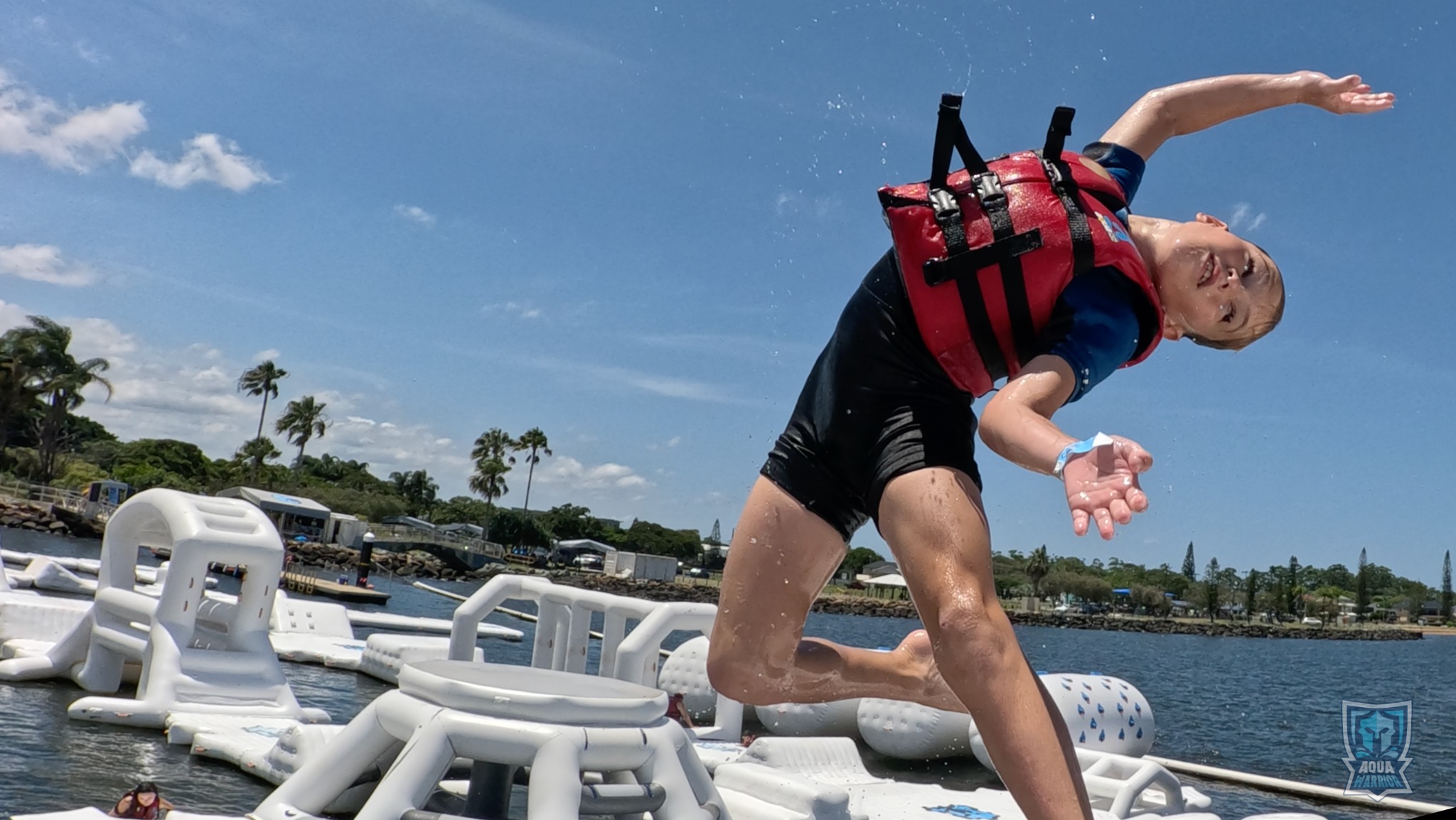 A young Aqua Warrior airborne above the obstacle course