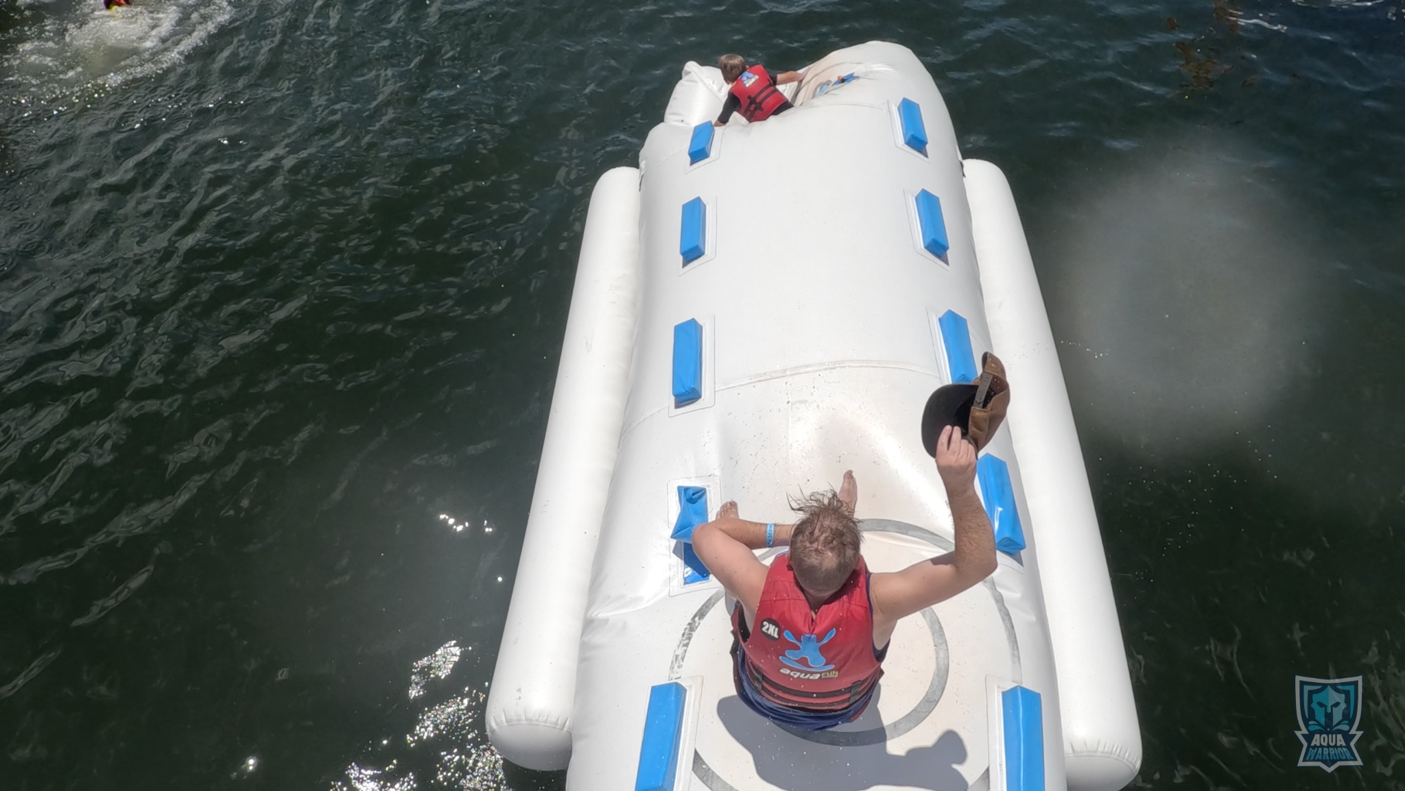 Overhead view of guests climbing an Aqua Warrior obstacle