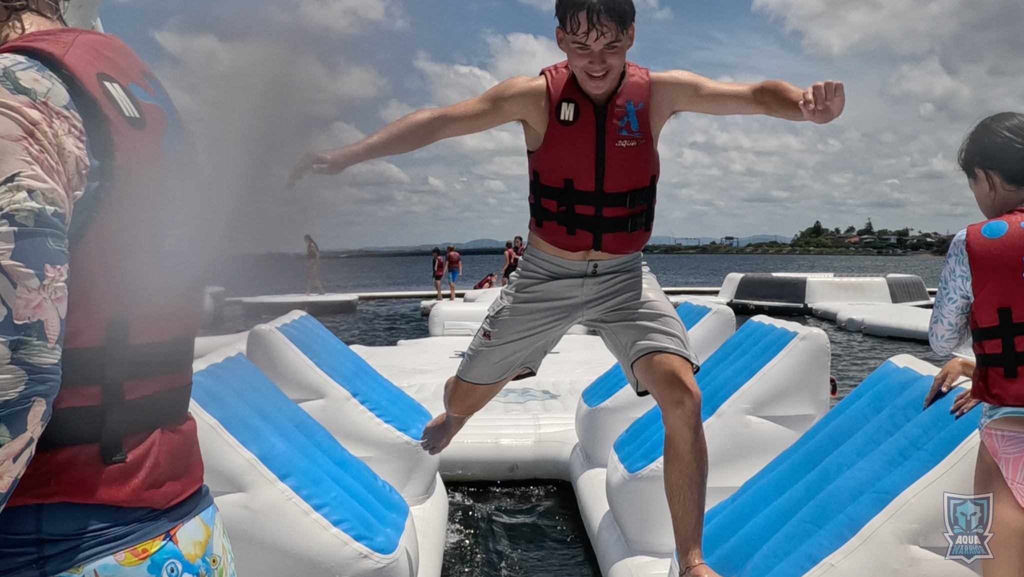 Aqua Warrior guest balancing between blue and white obstacles
